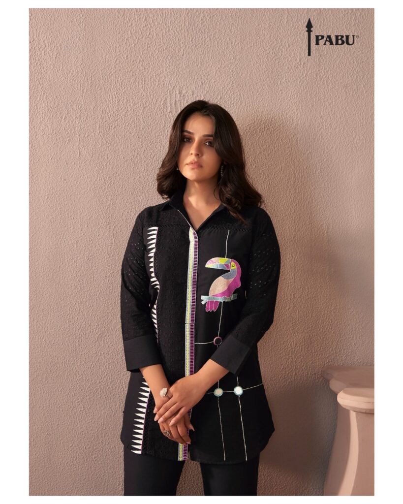 Black Shirt-Style Kurta Set with Parrot Embroidery A bold fusion of modern cuts and artistic flair. Features a playful embroidered parrot and clean lines. Ideal for stylish outings and statement dressing.